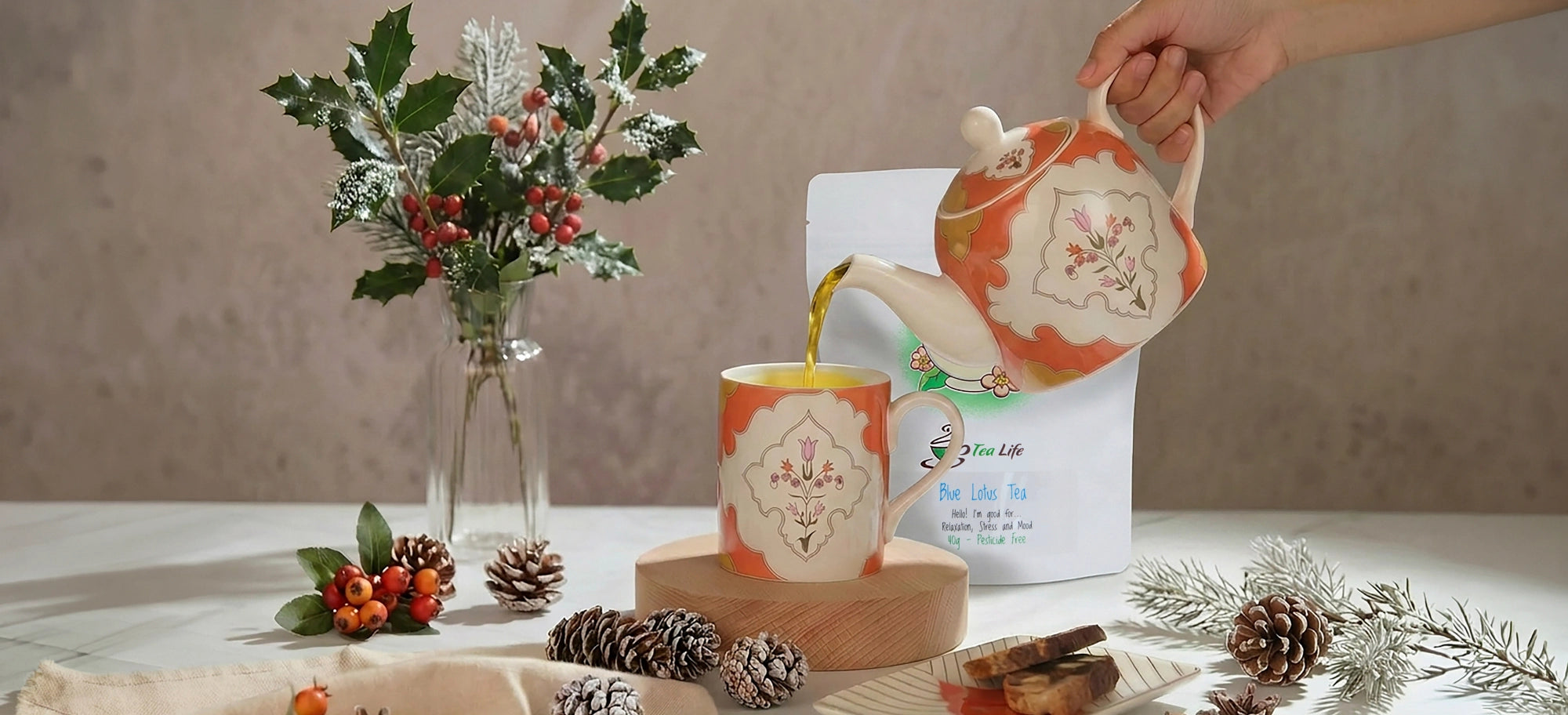 Tea-making scene with a teapot, mug, and decorative elements on a table.