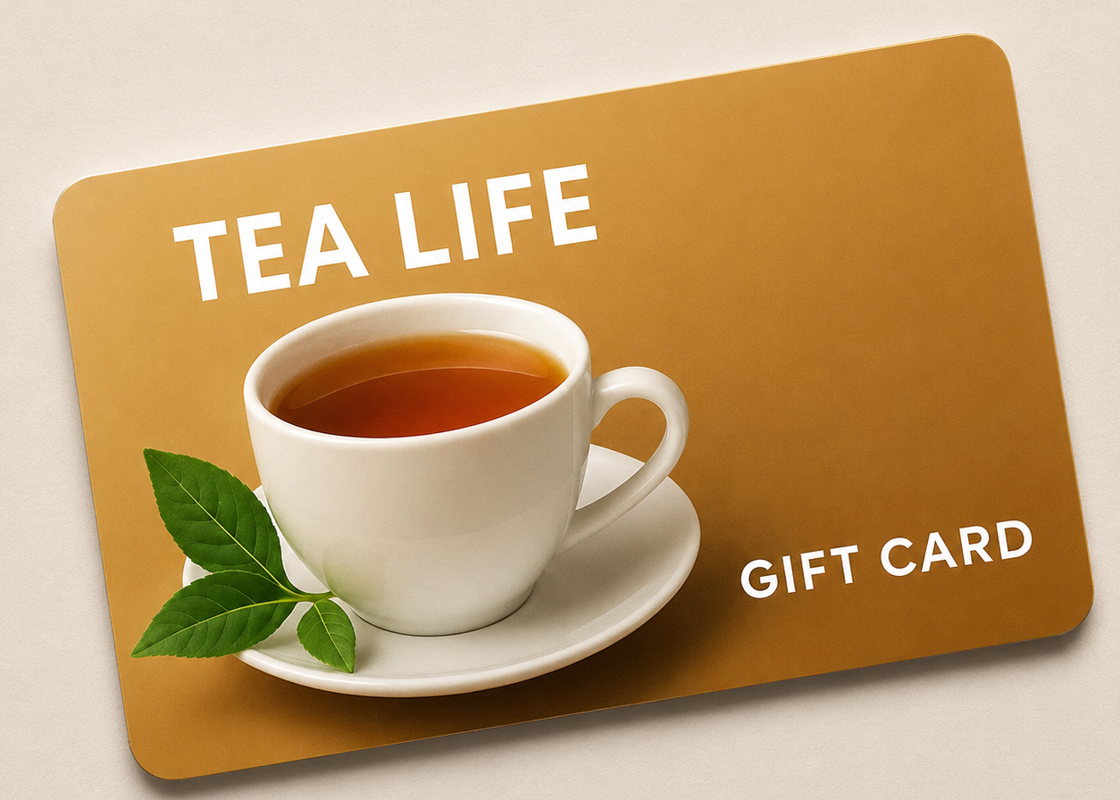 A rectangular gift card with rounded corners on a light beige background. The card is tan/golden brown with white text reading 'TEA LIFE' and 'GIFT CARD', plus a printed image of a white teacup and saucer with green tea and leaves.
